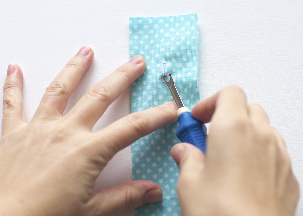 use a seam ripper to create a buttonhole